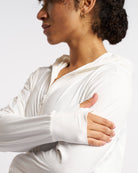 Close-up of white UV-protective jacket sleeve with thumbhole for added comfort and coverage.