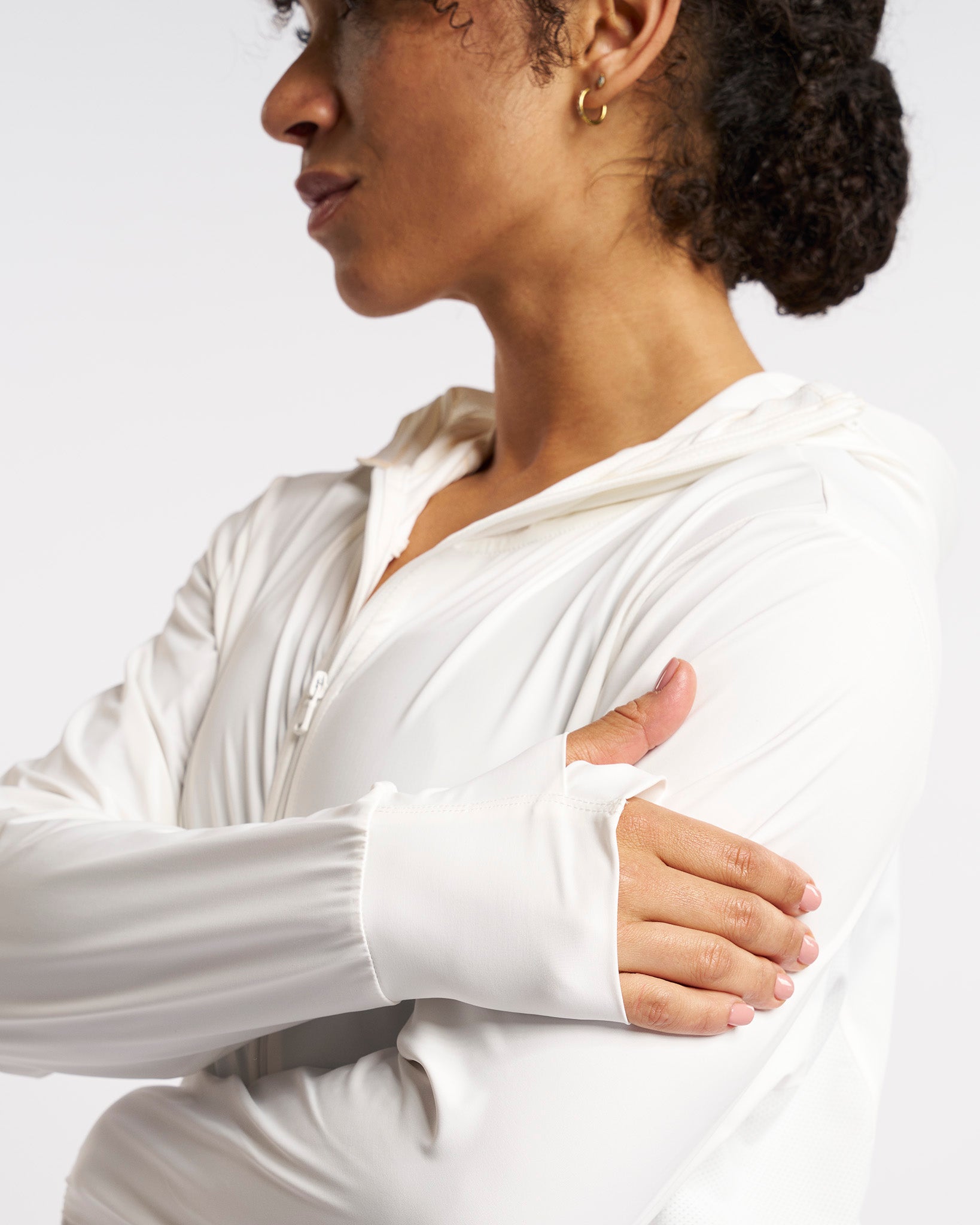 Close-up of white UV-protective jacket sleeve with thumbhole for added comfort and coverage.