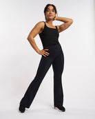 Model wearing black Stelle womens flare leggings with pockets, high-waisted fit, and flared leg style