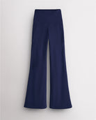Indigo Stelle womens flare leggings with pockets, high waistband, and flared leg design on white background