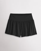 Women’s black 2-in-1 high waisted athletic shorts with a flowy outer layer, built-in shorts, and side slit detail.