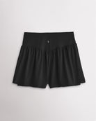 Back view of women’s black high waisted athletic shorts with a flowy layered design and V-contour back seam.