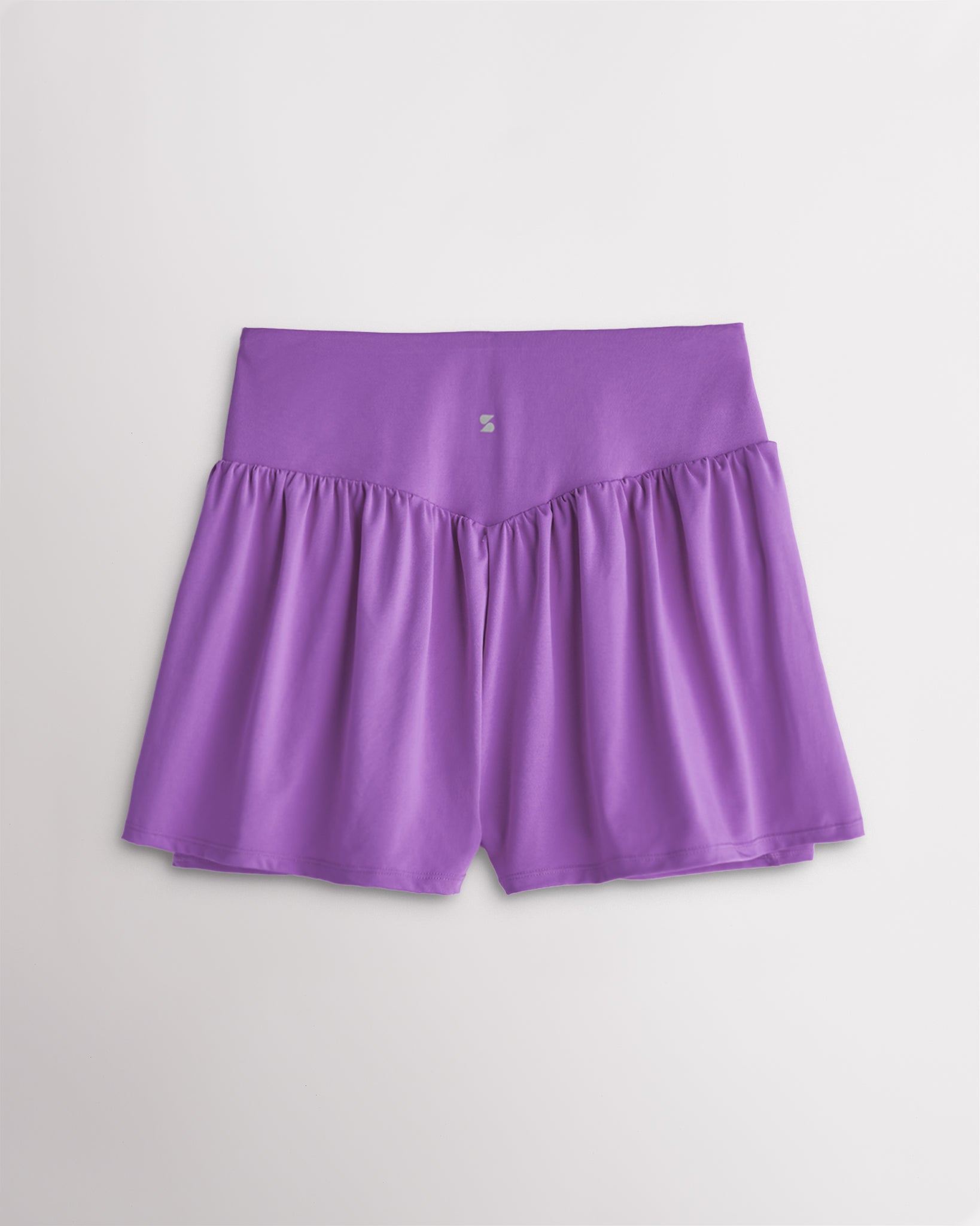 Back view of women’s lavender high waisted athletic shorts with a flowy layered design and V-contour back seam.