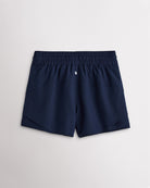 Back view of women’s navy running shorts with a high-rise elastic waistband and layered hem design.