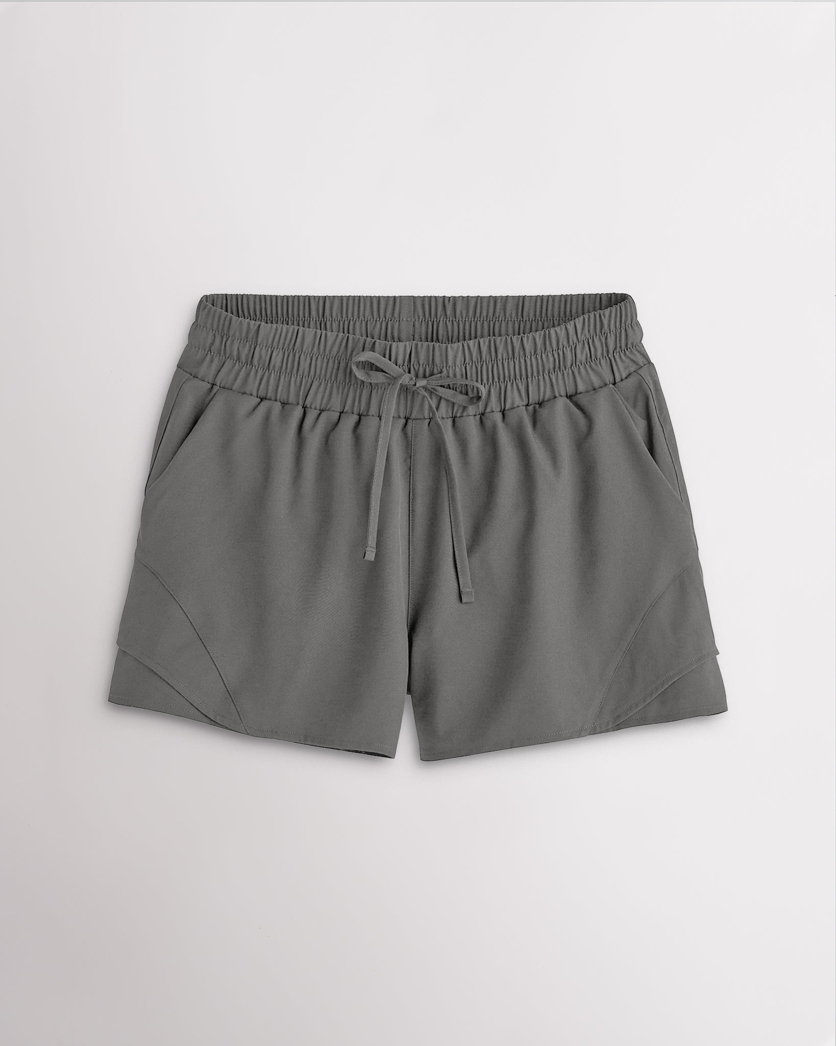 Women’s smoke grey high-rise running shorts with a wide elastic waistband, drawstring tie, side pockets, and double-layer hem.