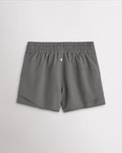 Back view of women’s smoke grey running shorts with a high-rise elastic waistband and layered hem design.