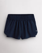 Navy Stelle RushMode 2-in-1 running shorts with wide elastic waistband, zipper pockets, inner shorts lining, and curved dolphin hem.