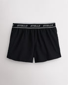 Black Stelle women's running shorts with a white logo waistband, laid flat on a grey background.