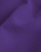Close-up of purple Stelle stretchy flared skater skort showing softly textured fabric detail.