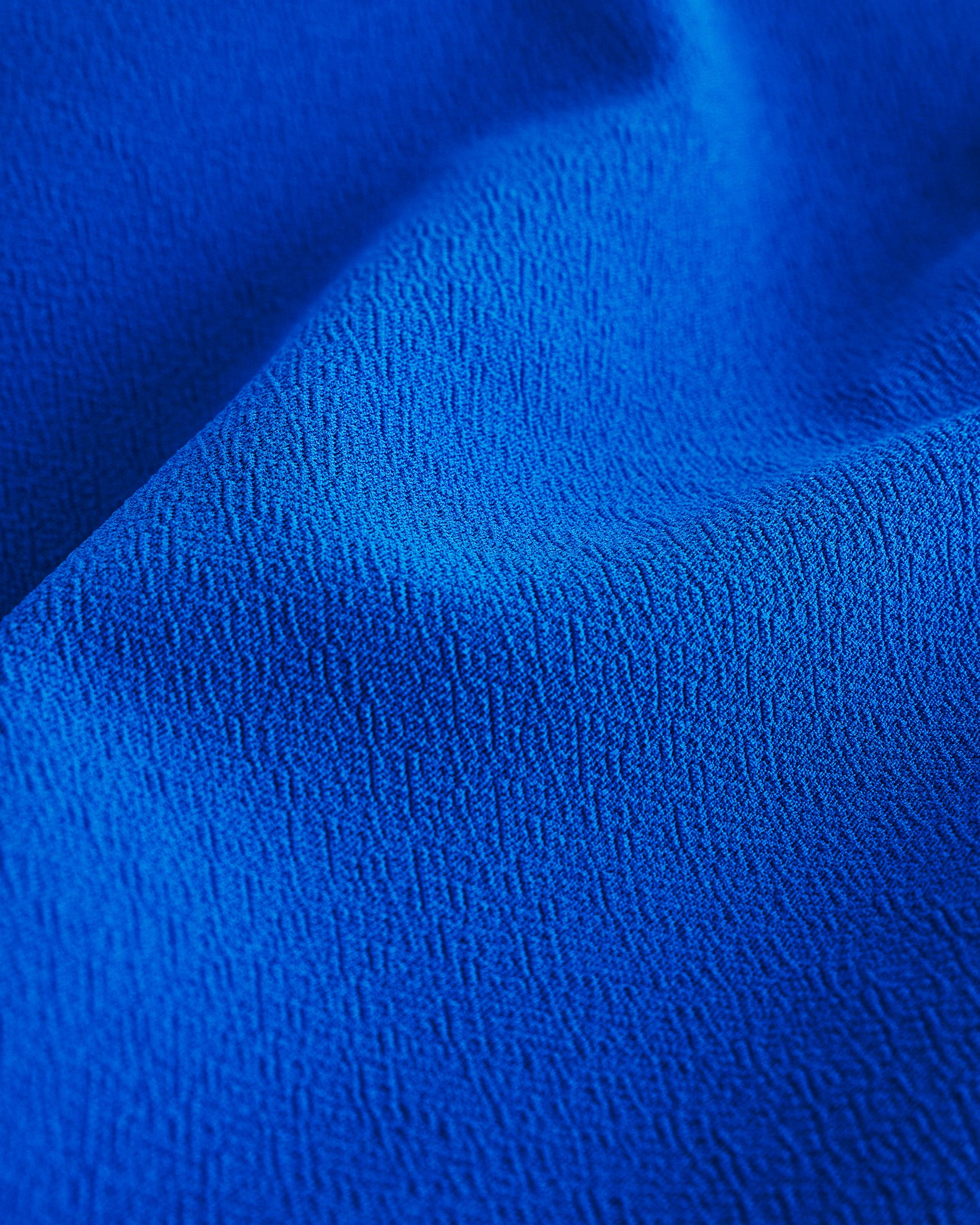 Close-up of Cobalt blue textured fabric from a flared skater casual skort.