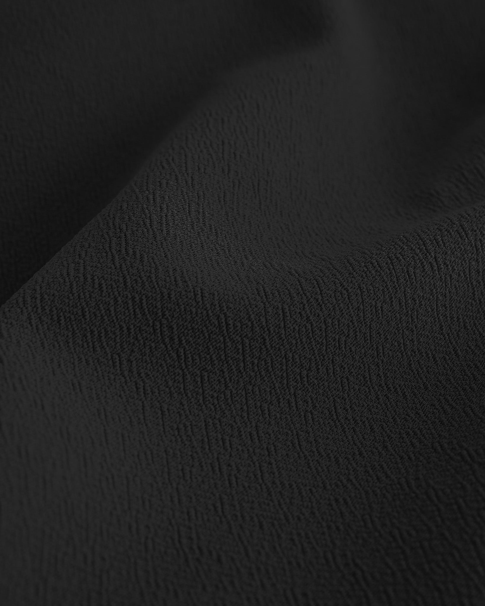 Close-up of black textured fabric from a flared skater casual skort.