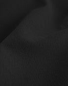 Close-up of black textured fabric from a flared skater casual skort.