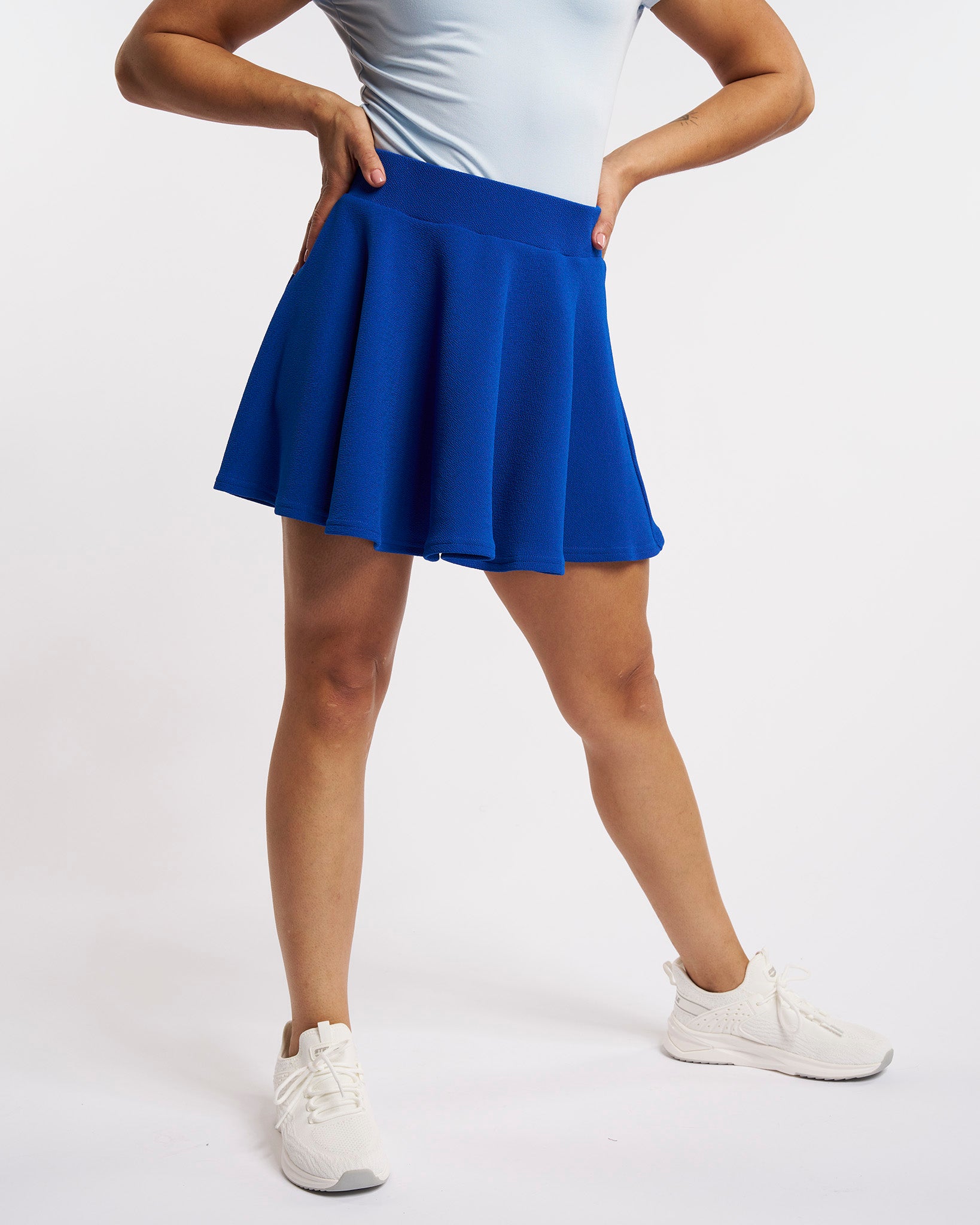 Cobalt blue flared skater casual skort worn by a woman.