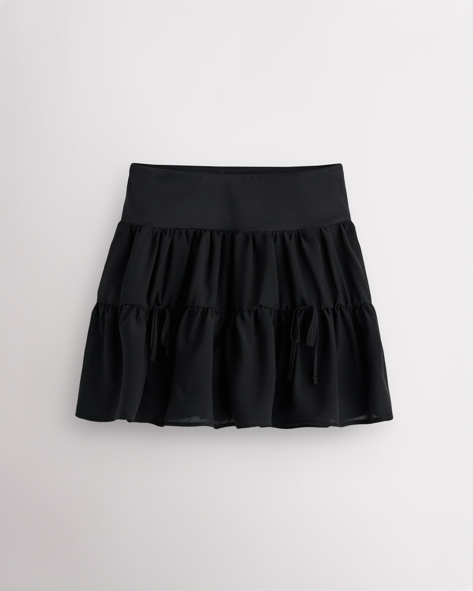 Black flowy layered tennis skort with tiered chiffon layers and high-rise waistband
