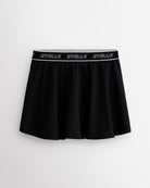 Black Stelle tennis skirt with black logo elastic waistband, high-waisted fit, flared skirt, and built-in shorts.