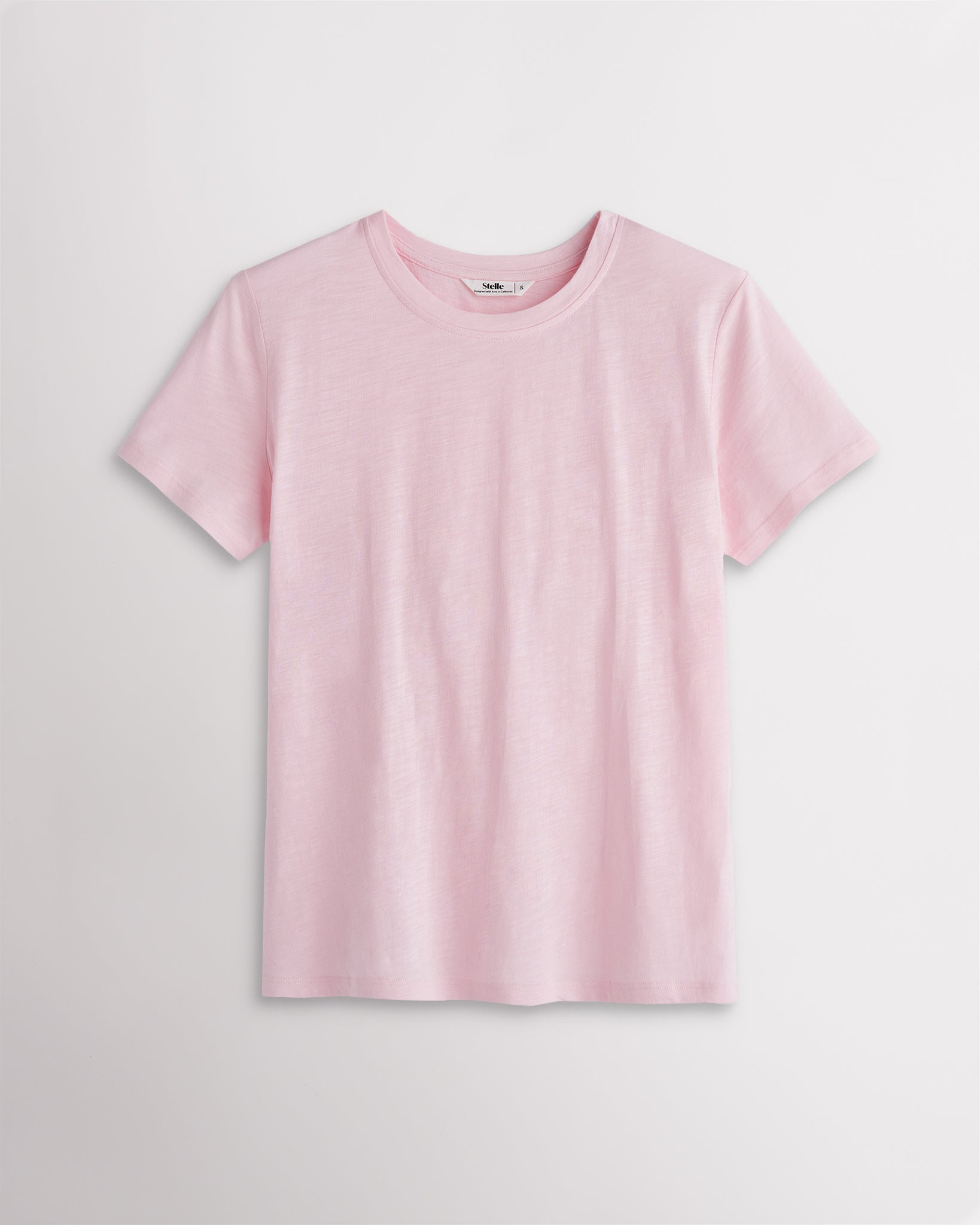 Women’s light pink classic short sleeve crewneck T-shirt with a relaxed fit, soft drape, and clean everyday silhouette.