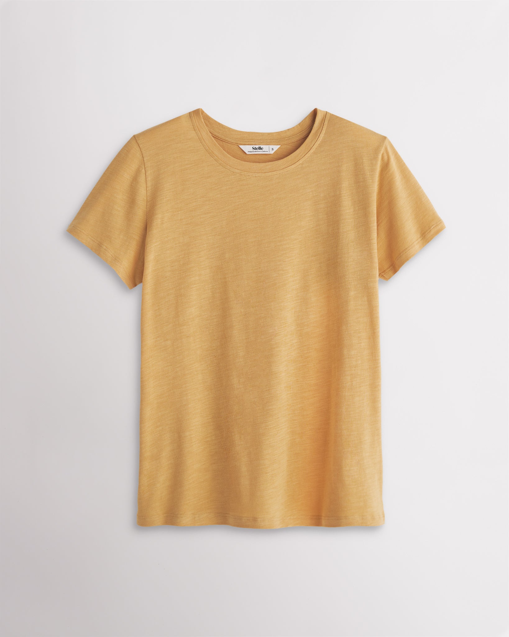 Mustard women’s classic short sleeve crewneck T-shirt with relaxed fit, soft modal-blend fabric, and everyday casual style.