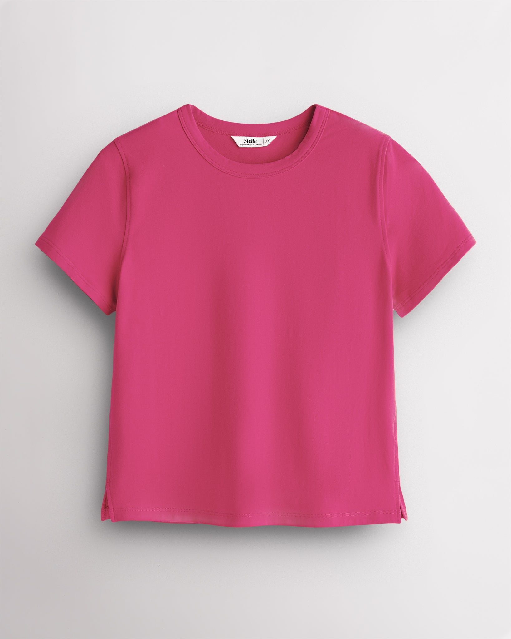 Deep pink Stelle womens short sleeve basic t shirt with crewneck, relaxed boxy fit, and side slits on white background