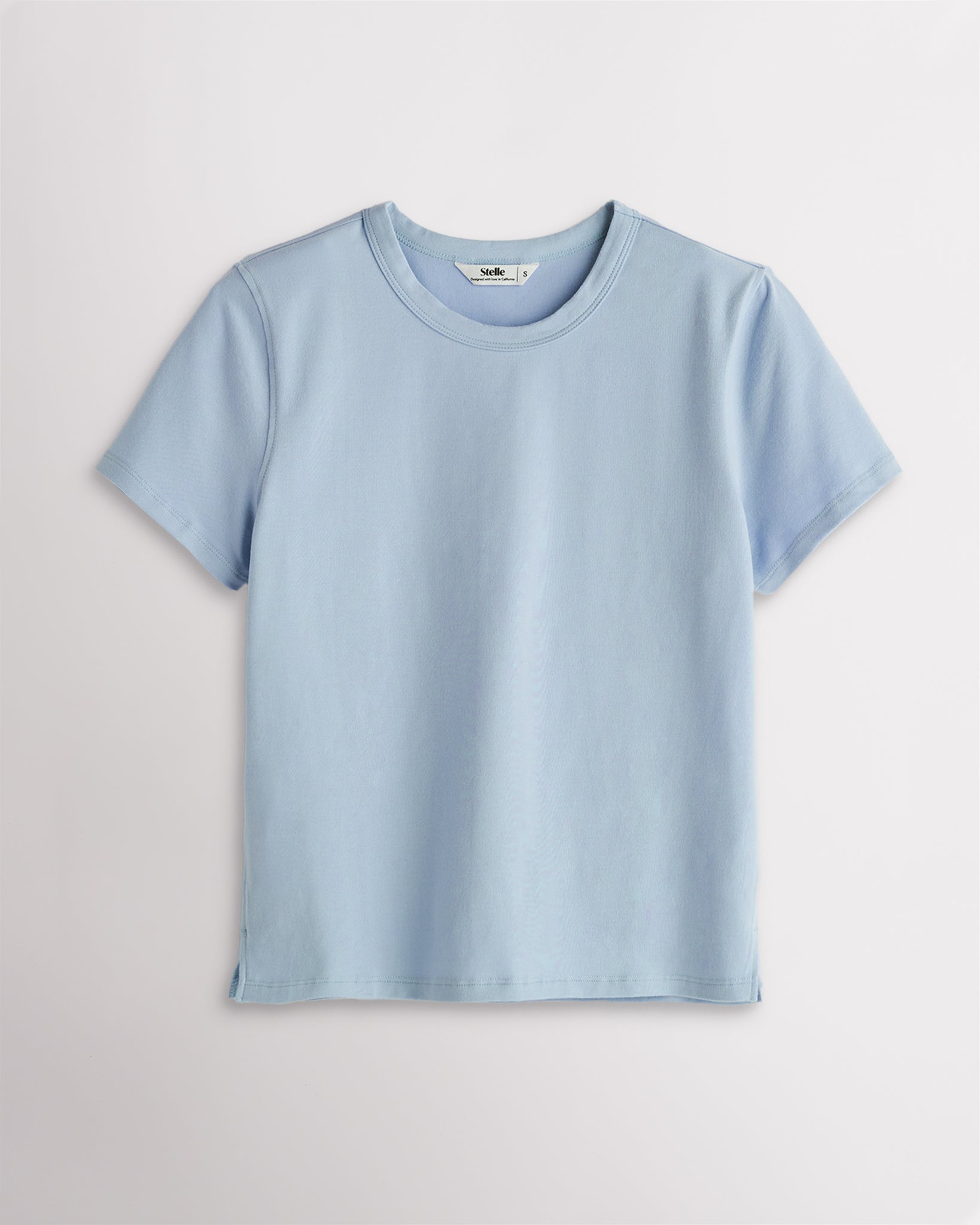 Women’s light blue short sleeve T-shirt with a relaxed fit, crew neckline, and subtle side slit hem.