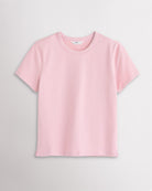 Light Pink Stelle womens short sleeve basic t shirt with crewneck, relaxed boxy fit, and side slits on white background