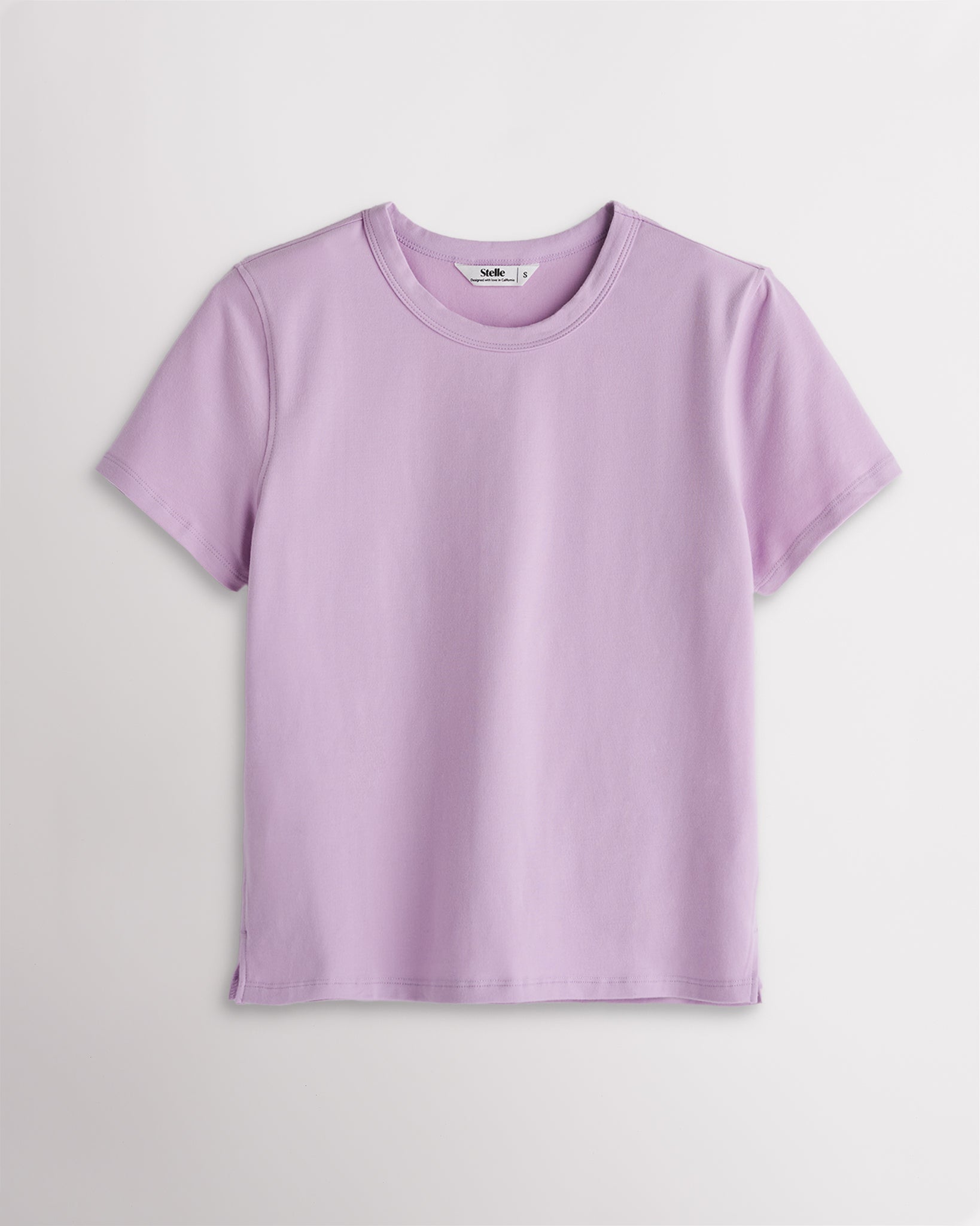 Women’s light purple short sleeve T-shirt with a relaxed fit, crew neckline, and subtle side slit hem.