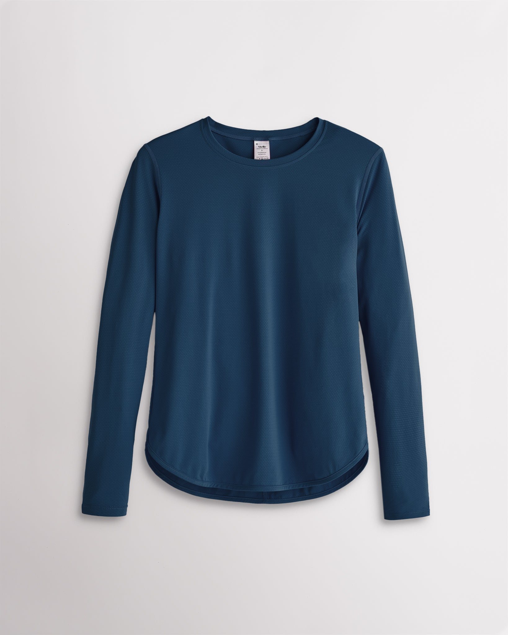 Women’s dark blue UPF 50+ long sleeve sun protection shirt with curved hem and lightweight breathable fabric.