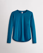 Women’s peacock blue UPF 50+ long sleeve sun protection shirt with curved hem and lightweight breathable fabric.