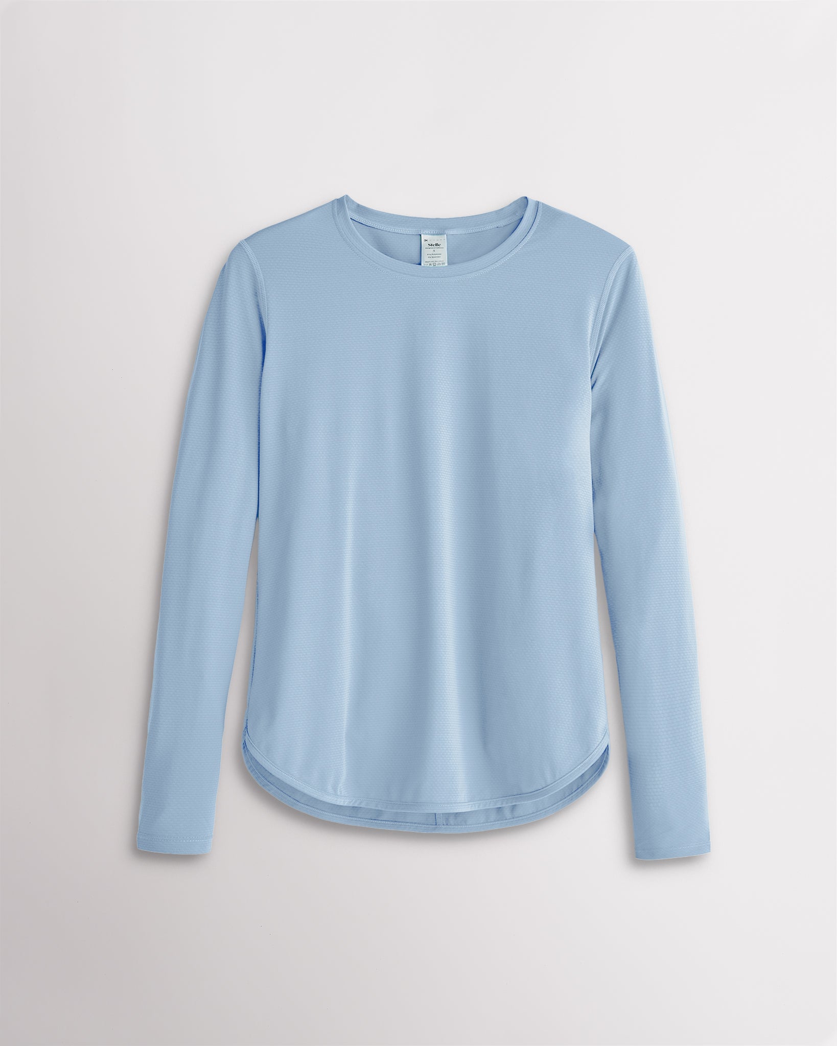 Women’s sky blue UPF 50+ long sleeve sun protection shirt with curved hem and lightweight breathable fabric.