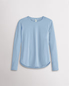 Women’s sky blue UPF 50+ long sleeve sun protection shirt with curved hem and lightweight breathable fabric.