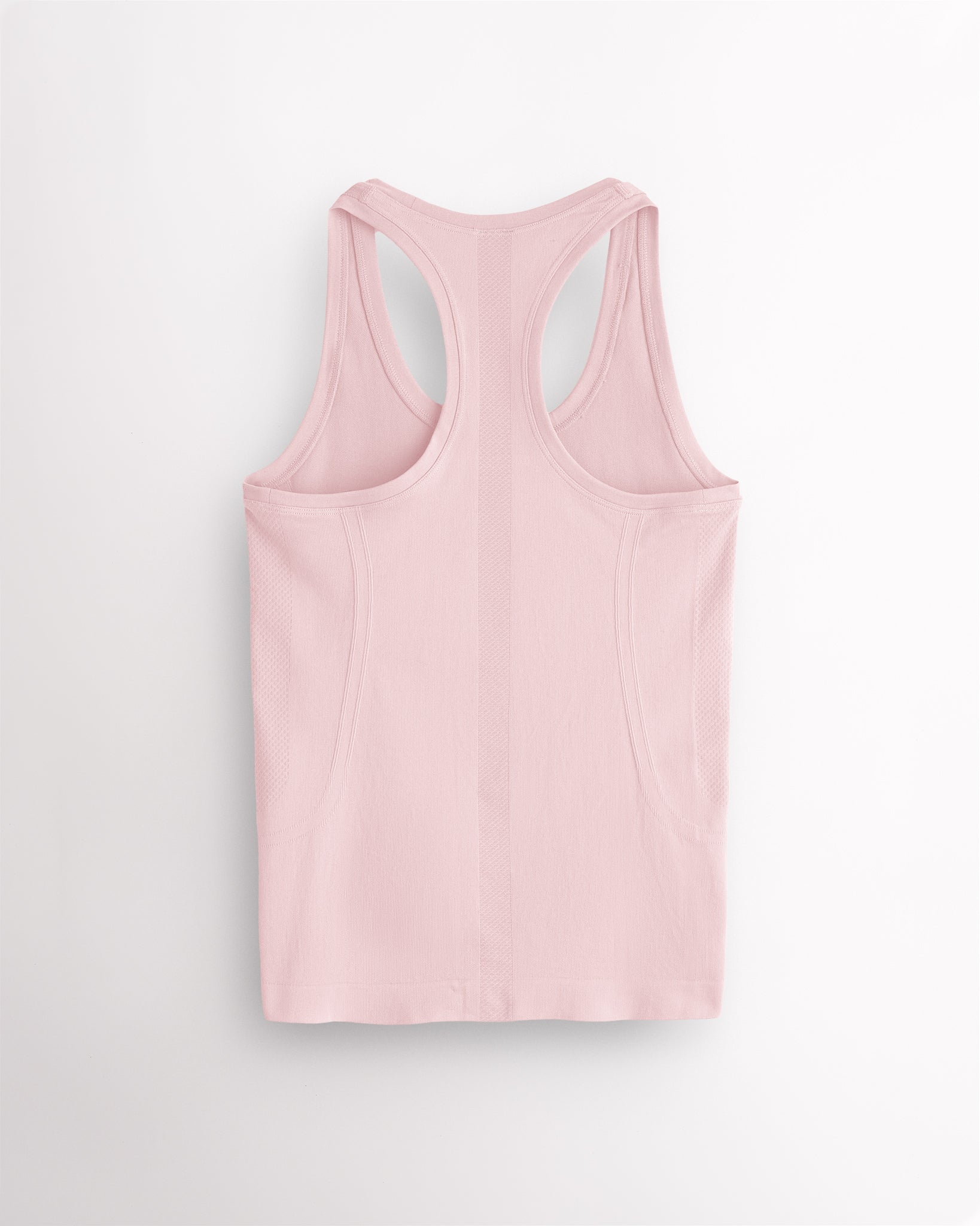Back view of the ballet pink Stelle seamless tank top, laid flat to show the racerback straps.