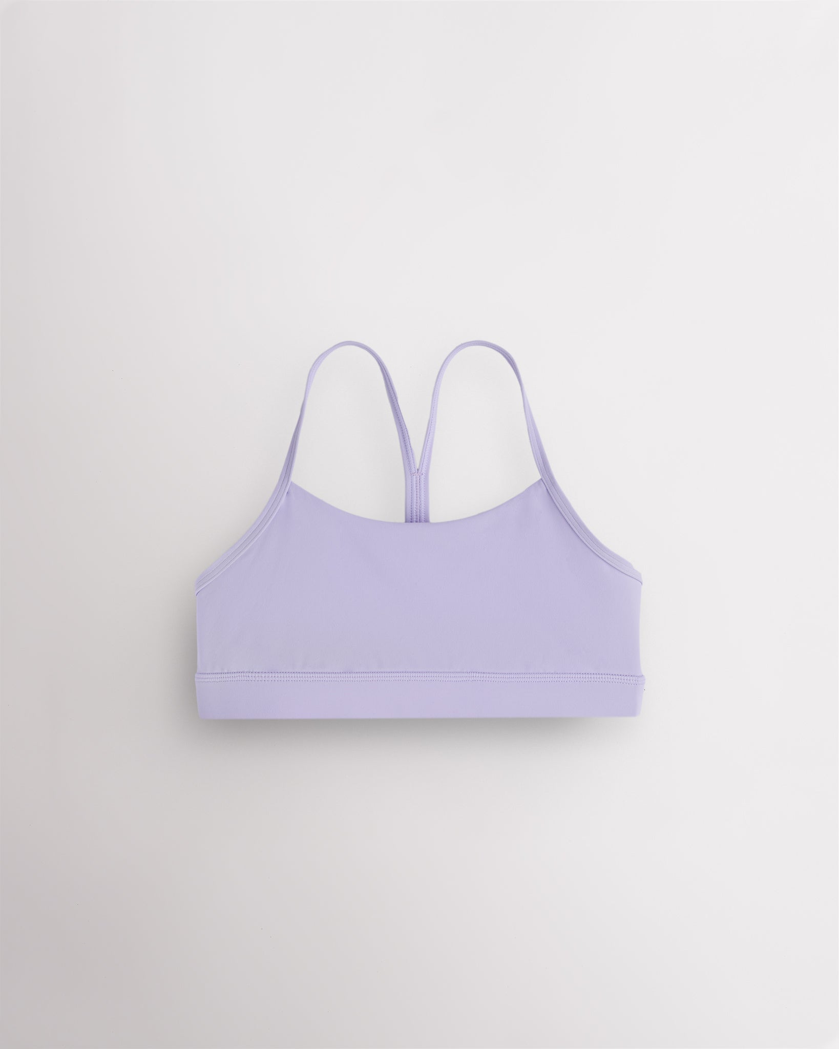 Lavender girls Y-back sports bra with thin straps, soft stretch fabric, and a supportive band.