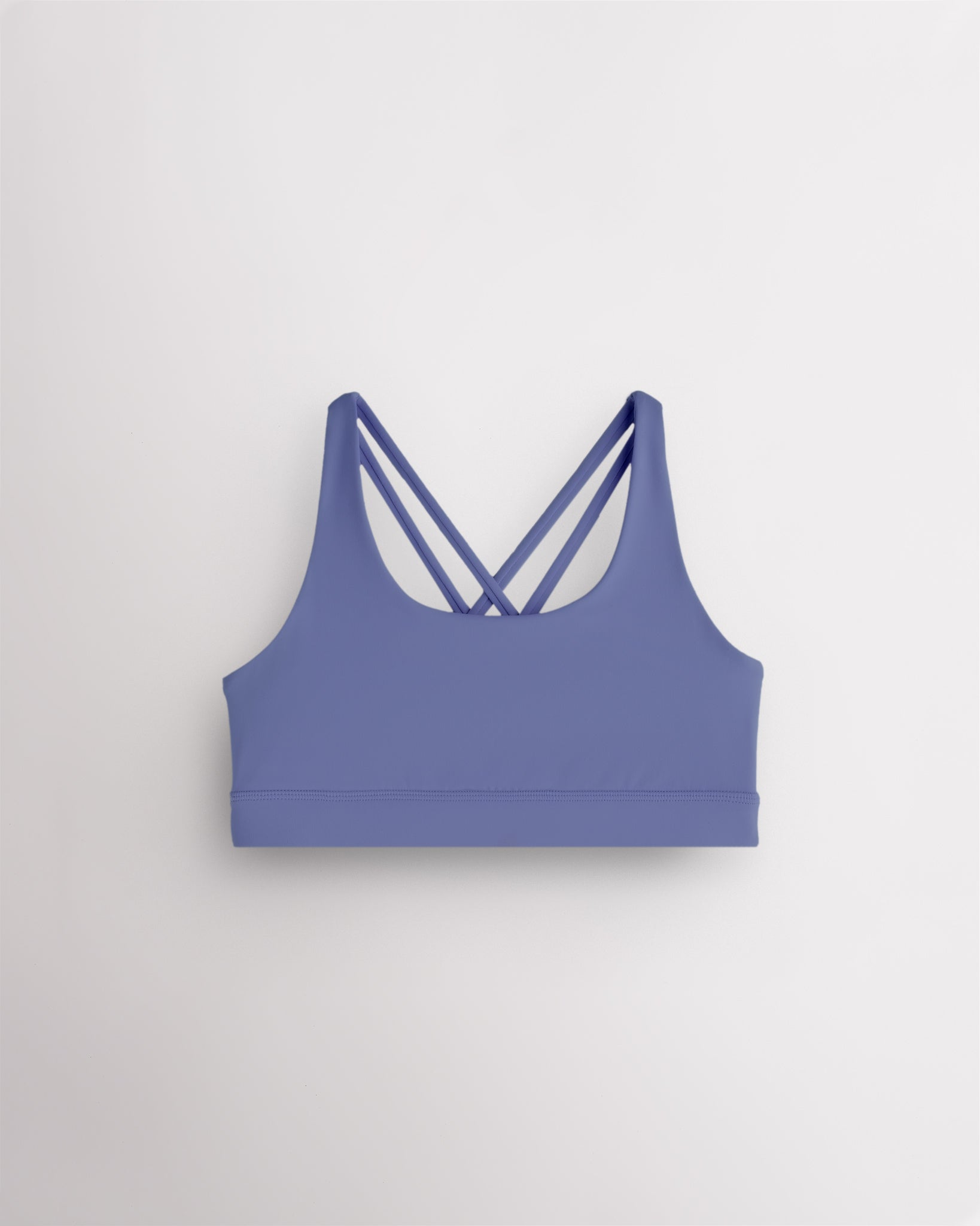 Periwinkle girls strappy sports bra with criss-cross racerback design, soft stretch fabric, and supportive band.