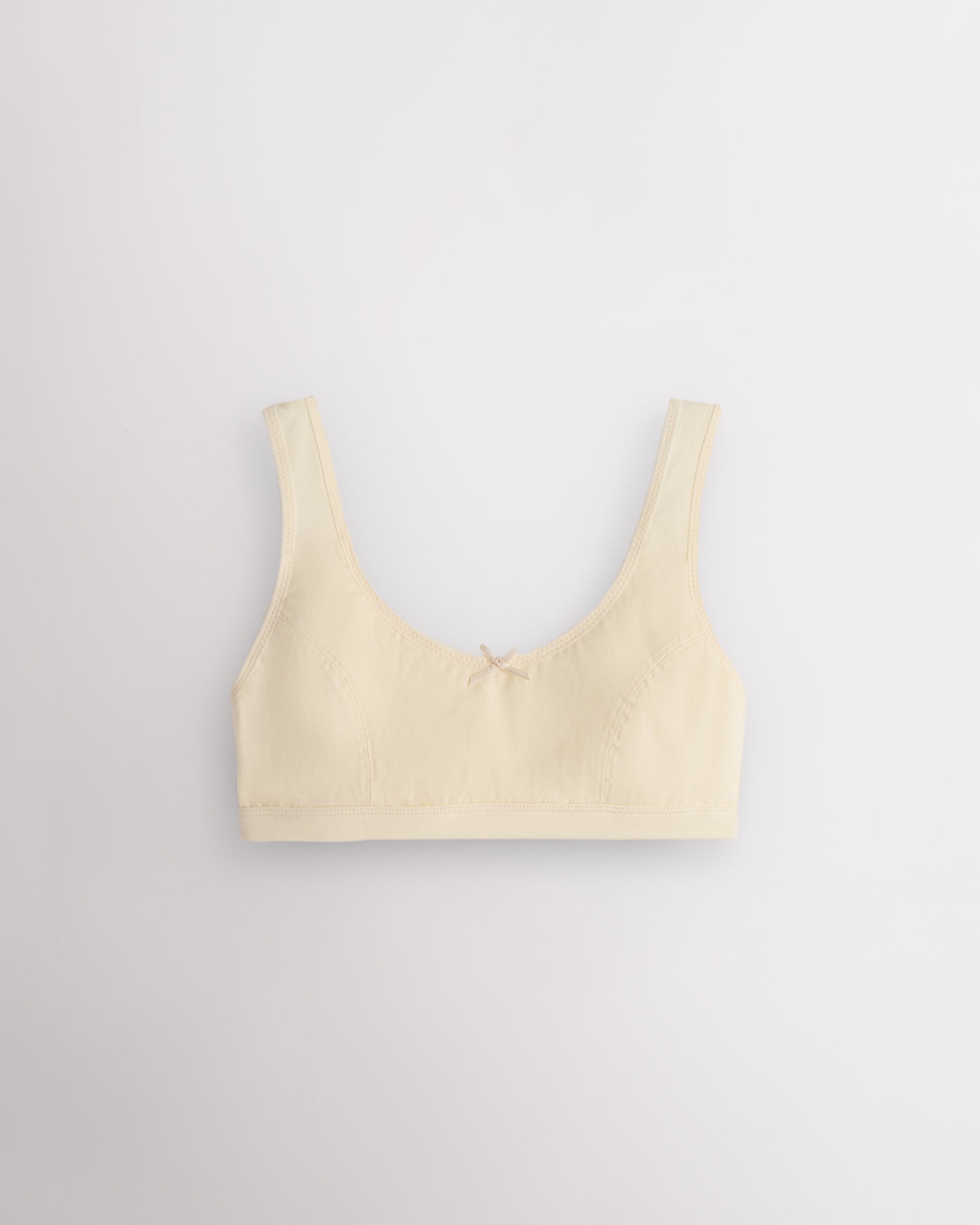 Stelle girls cotton bralette in soft butter with wide straps, soft lining, and small bow detail