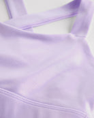 Close-up of lavender metallic girls tank top showing iridescent shimmer fabric and smooth seam detail.