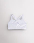 Back view of white metallic dance top with criss-cross racerback straps and a supportive band.