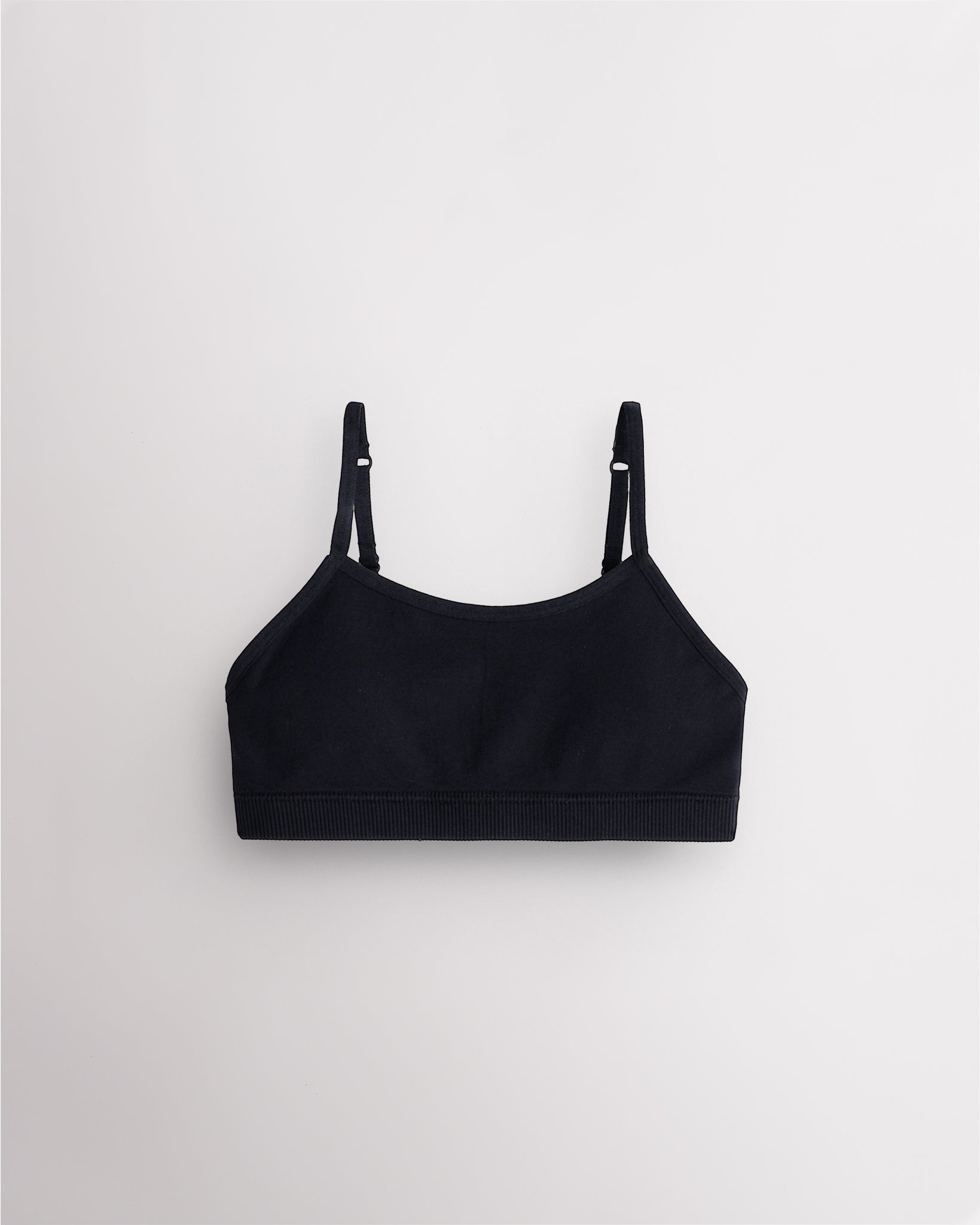 Black Stelle girls seamless cami bra with slim adjustable straps and soft ribbed support band.
