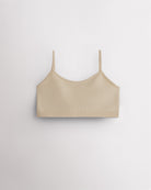 Beige Stelle girls seamless cami bra with thin adjustable straps, shown flat.