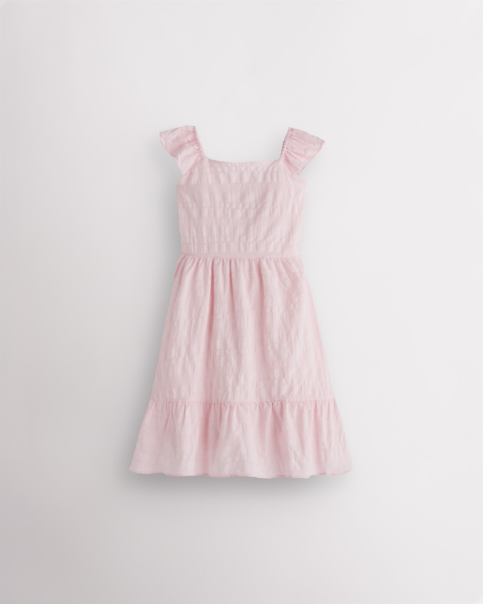 Girls light pink flutter sleeve sundress with square neckline, smocked waist, and tiered hem, lightweight summer dress front view