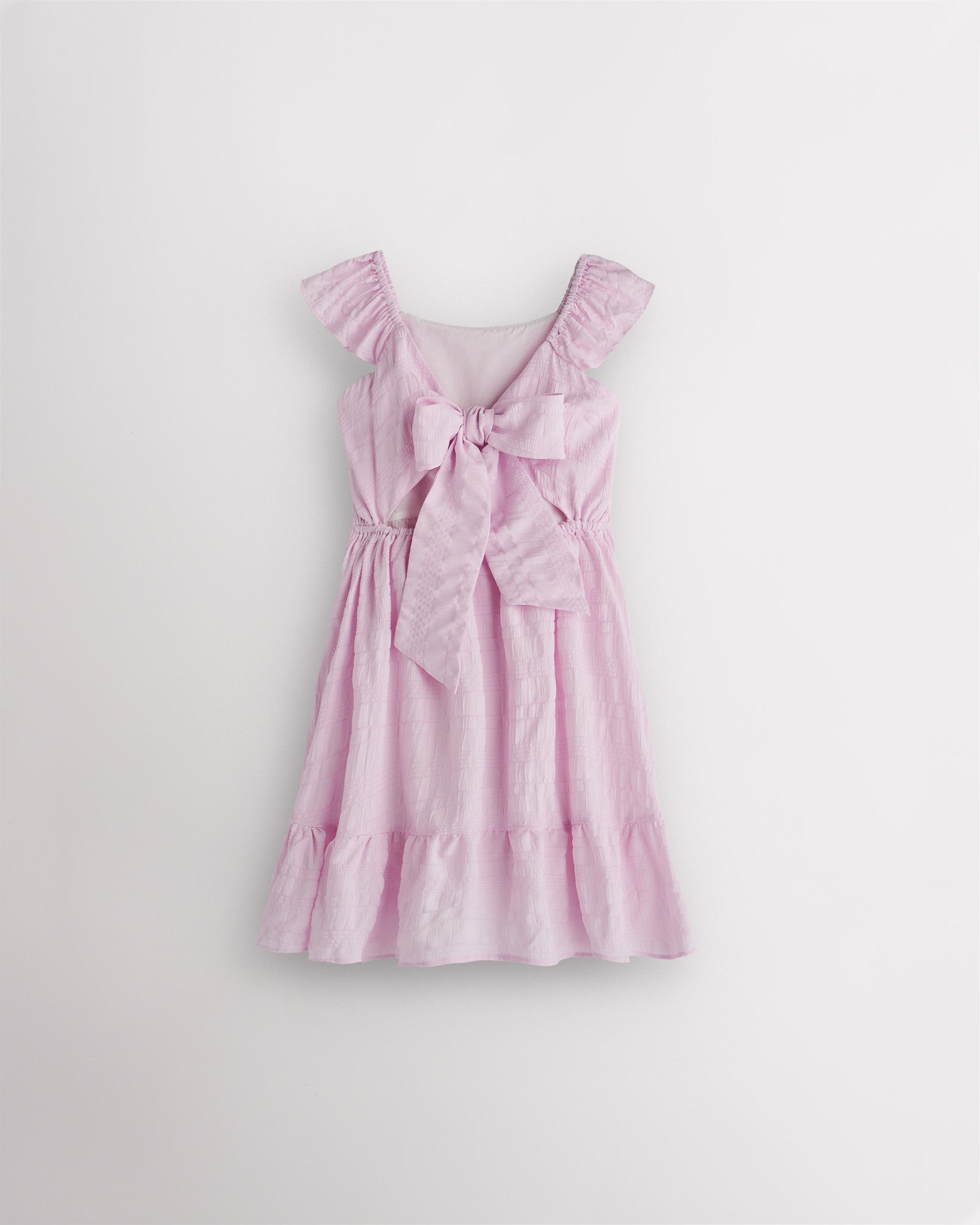 Girls lilac flutter sleeve sundress with adjustable bow back, smocked waist, and tiered skirt, back view showing bow detail