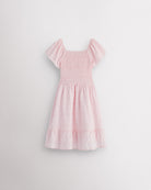 Back view of light pink girls summer dress showing smocked back, short sleeves, and soft gathered skirt.