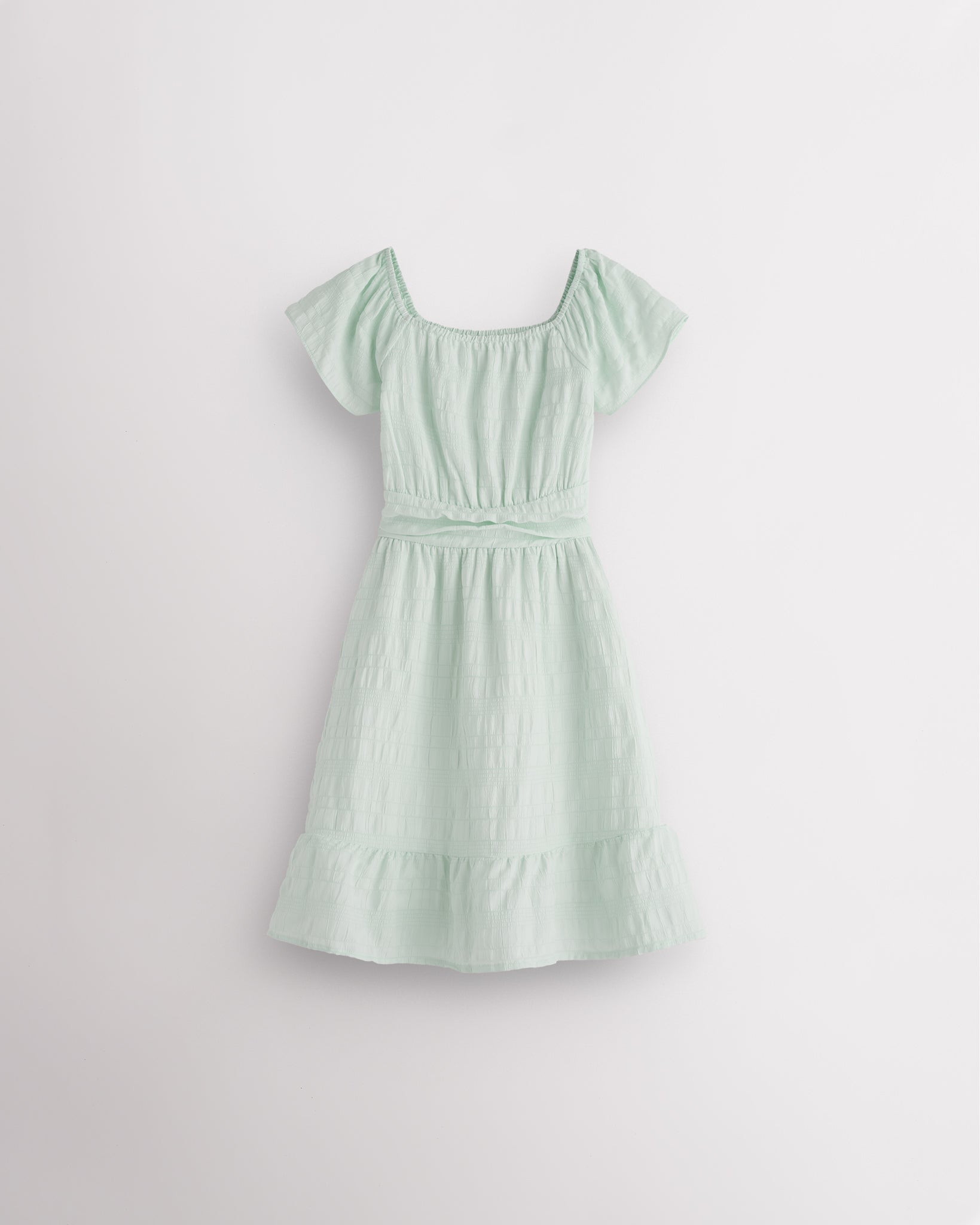 Pastel Green girls smocked summer dress with short sleeves, square neck, fit-and-flare shape, and ruffle hem.