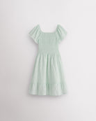 Back view of Pastel Green girls summer dress showing smocked back, short sleeves, and soft gathered skirt.