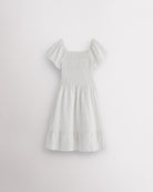 Back view of white girls summer dress showing smocked back, short sleeves, and soft gathered skirt.
