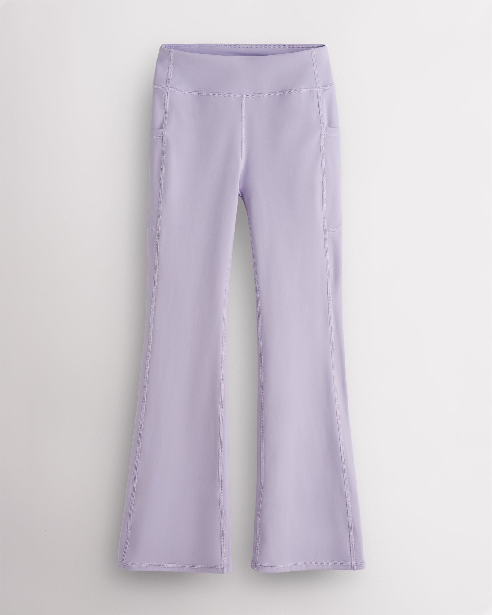 Lavender girls flare leggings with high waist, side pockets, sleek waistband, and flared hem for activewear and everyday movement.