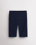 Navy girls 8-inch volleyball shorts with side pockets, wide waistband, seamless front, and stretch-knit fabric for court and active wear.