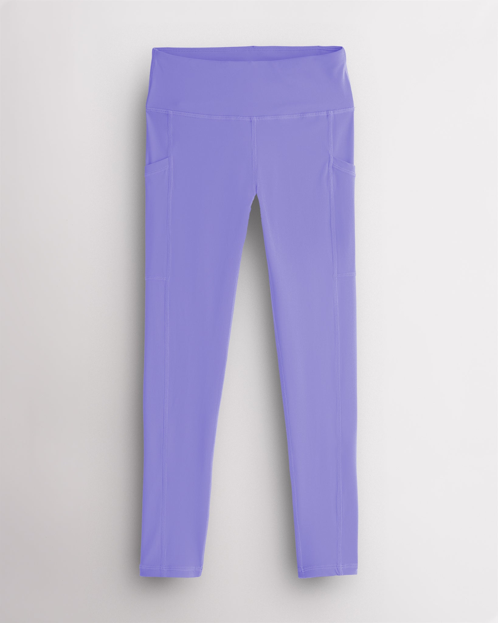 Periwinkle girls athletic leggings with side pockets, a wide supportive waistband, and soft stretch fabric for active and casual wear.