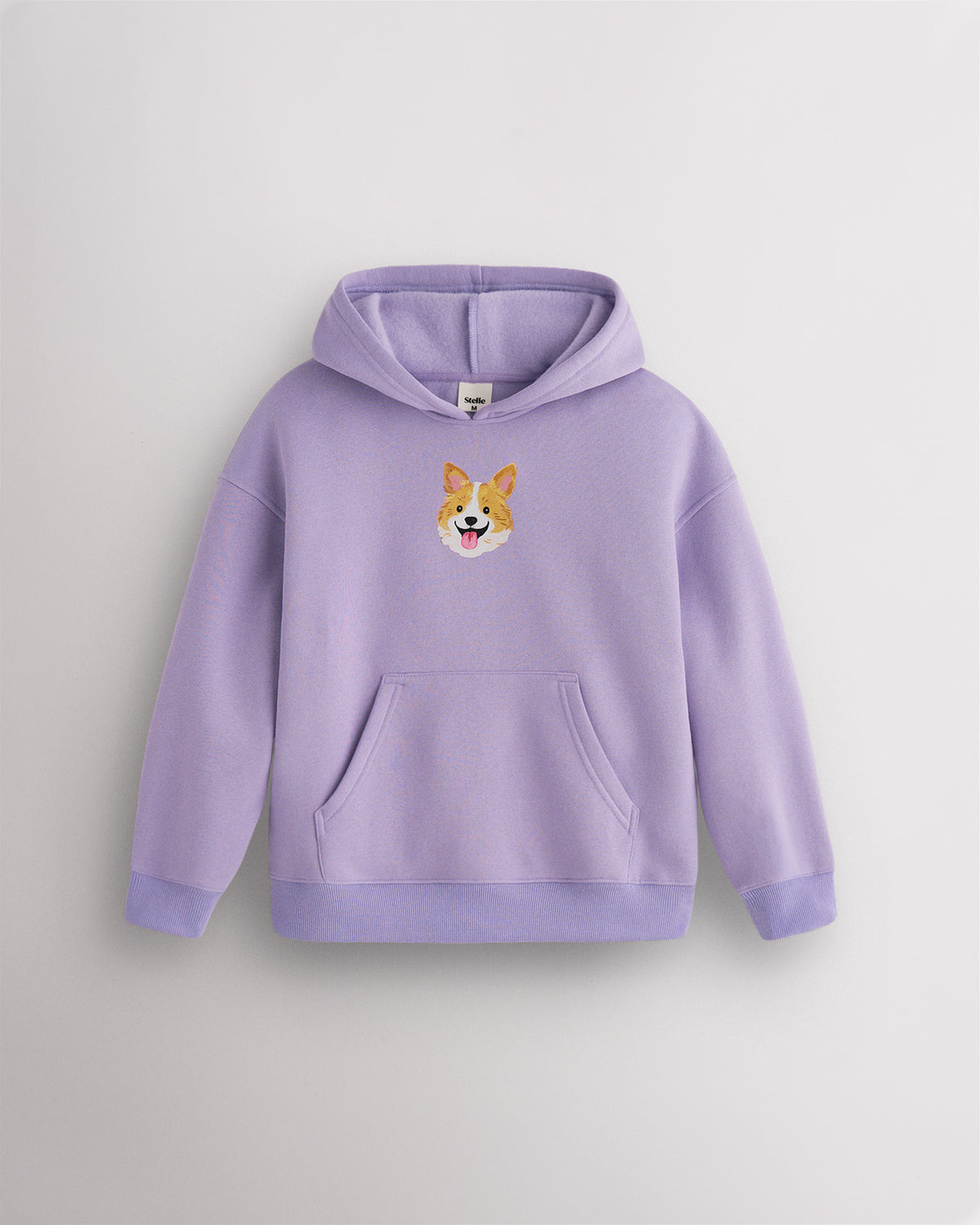 Lavender kids dog print hoodie laid flat with hood, front kangaroo pocket, ribbed cuffs and hem, and corgi graphic.