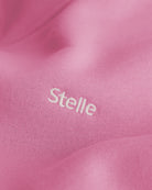 Close-up of the embroidered Stelle logo on the orchid fleece hoodie.