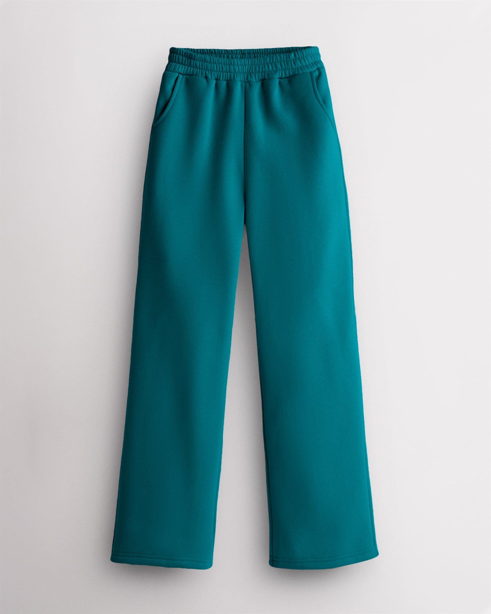 Teal Stelle kids fleece sweatpants with an elastic waist and side pockets.