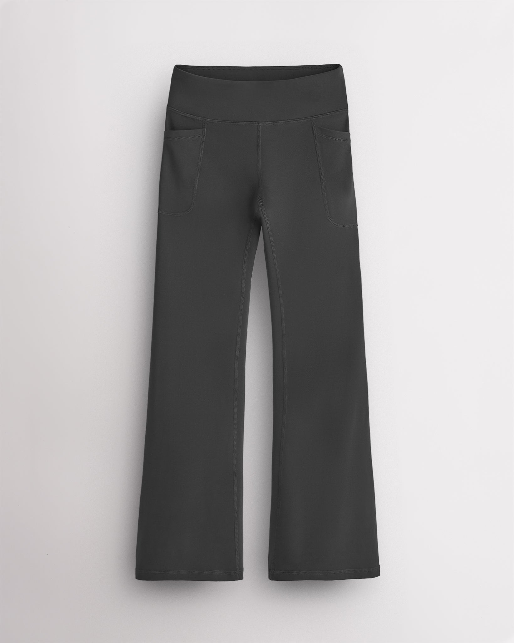 Charcoal girls leggings with a high waisted waistband, side pockets, and lightly flared bootcut legs, designed as active and casual flare leggings.